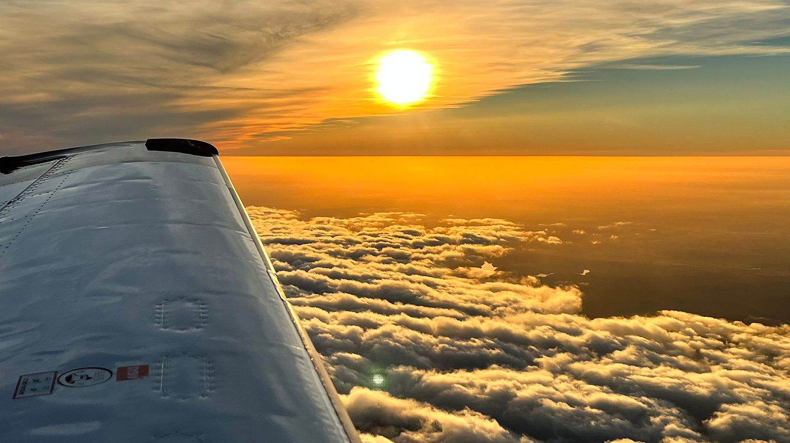 Shot of clouds and the sun while flying with SKY academy